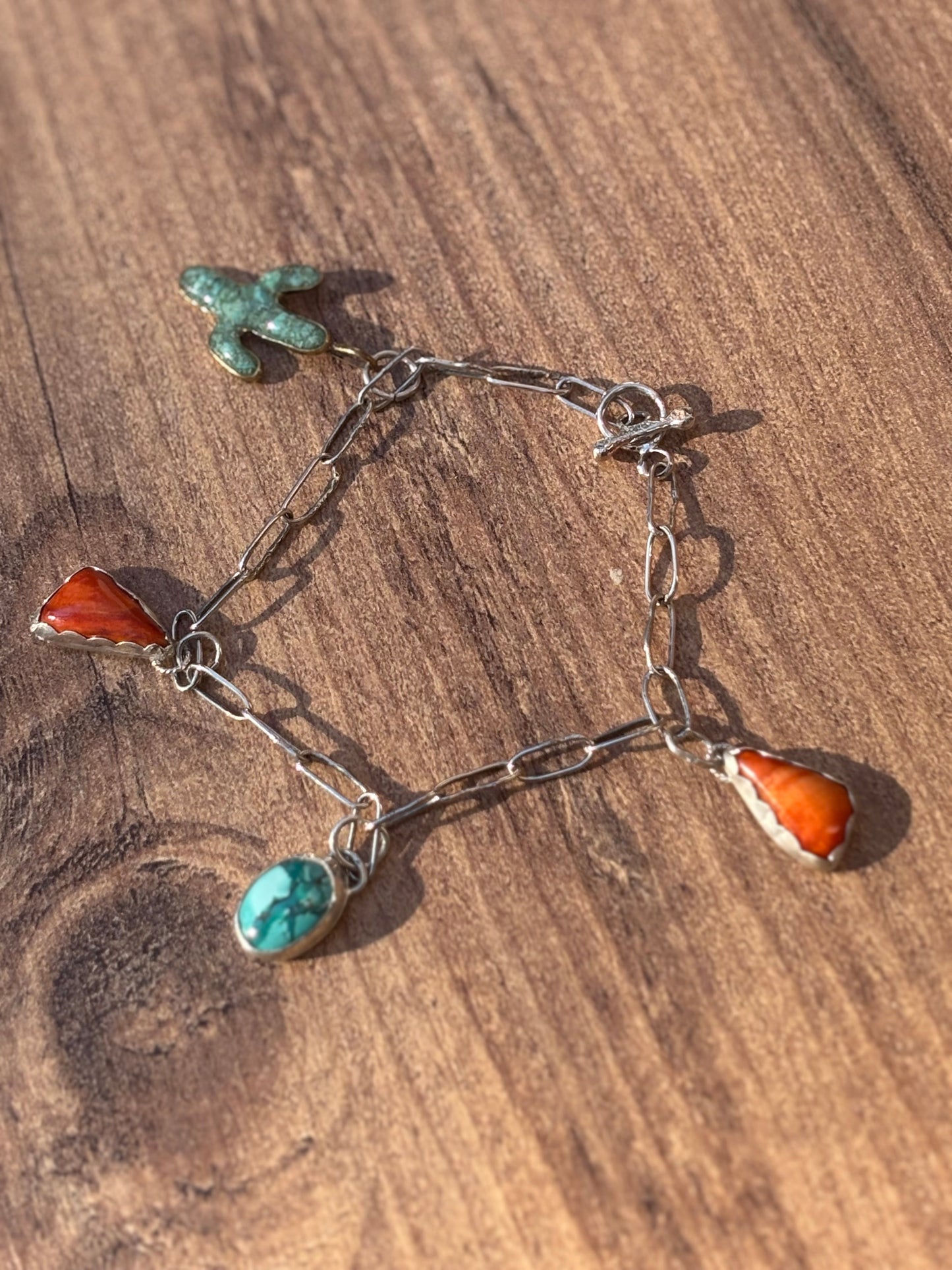 Sterling Silver Charm Bracelet with Brass Cactus Turquoise Inlay, Orange Spiny Oyster Shell, and Oval Turquoise Cabochon Charms